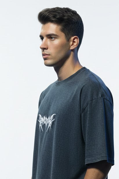 Man wearing a dark gray t-shirt with a logo on a white background